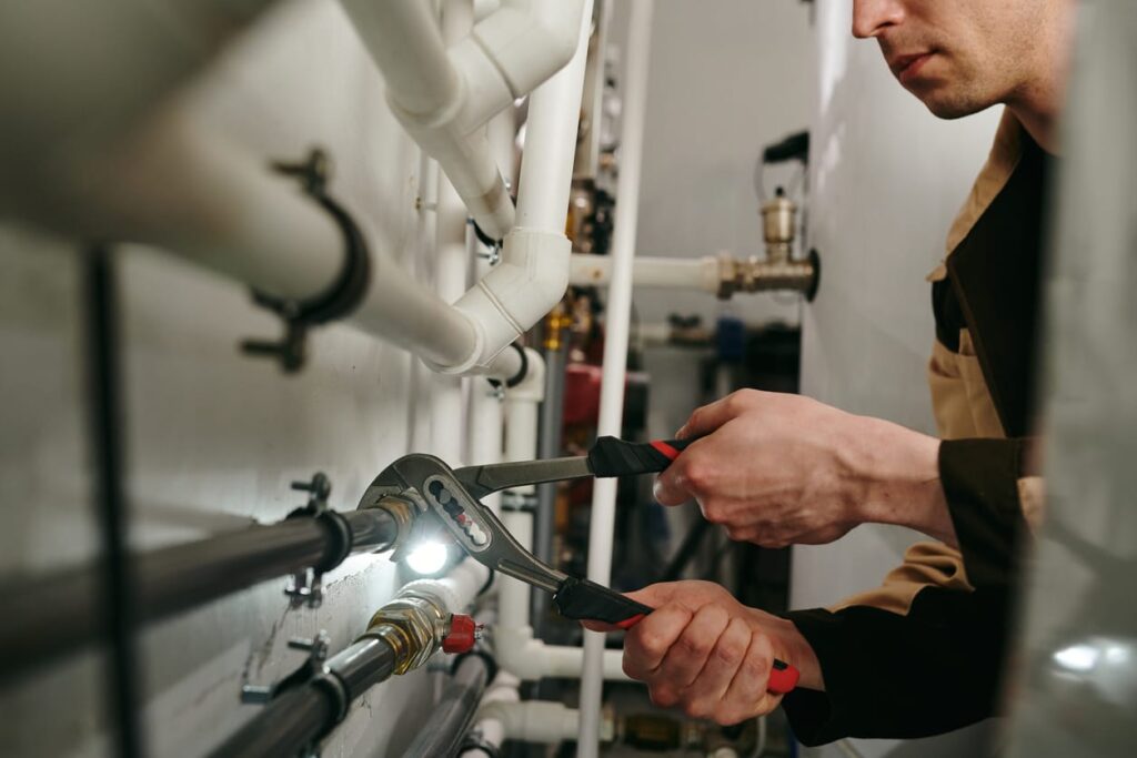 Plumbers maintaining commercial plumbing pipes in Loveland