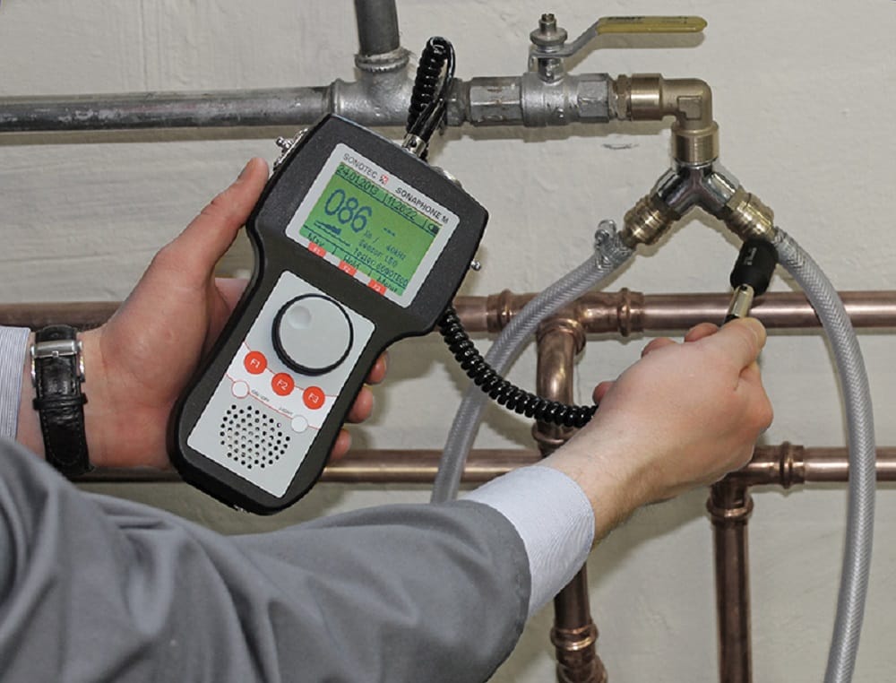 Plumber testing pipes with electronic leak detection equipment in Loveland