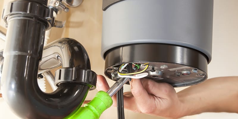 Technician repairing the heating element of a water heater in Loveland